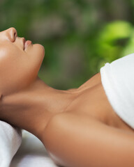 Close-Up Of Woman s Neck And Face Resting On Spa Bed With Soft Light