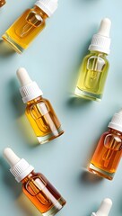 Assortment of Essential Oil Dropper Bottles on Blue Background