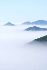 Misty Mountain Peaks Emerging from Sea of Clouds - Atmospheric Landscape