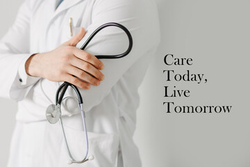 Doctor holding stethoscope promoting healthcare awareness with message “Care Today, Live Tomorrow” on gray background. Medical prevention and wellness concept