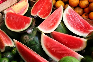 Red watermelons are tropical fruits that are juicy and sweet. Fresh watermelon slices are ready to...