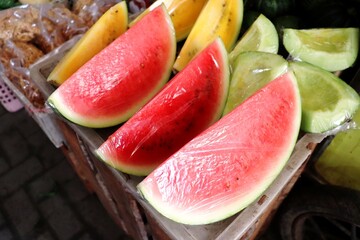 Red and yellow watermelons are tropical fruits that are juicy and sweet. Fresh watermelon slices...