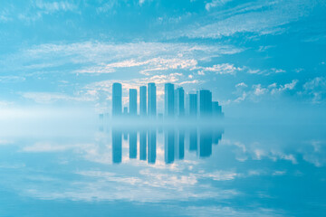 Fototapeta premium Modern city skyline reflected on tranquil water with a dreamy, misty atmosphere