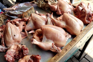Fresh raw butchered chicken sold at a traditional market. A basic ingredient for delicious and...