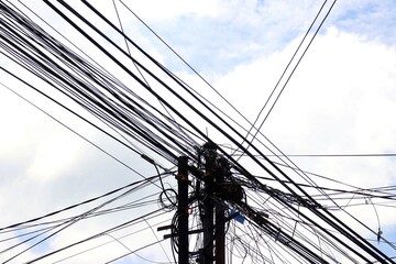 Messy and unorganized electrical cables are commonly seen in urban areas. Overhead high-voltage...