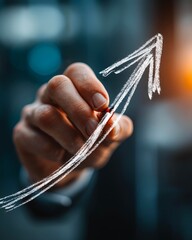 Close up of human hand drawing increasing arrow. Success and growth concept