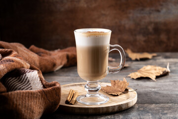 Maple Latte with Cinnamon in Glass Mug on wooden table