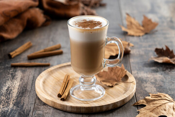 Maple Latte with Cinnamon in Glass Mug on wooden table