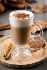 Maple Latte with Cinnamon in Glass Mug on wooden table