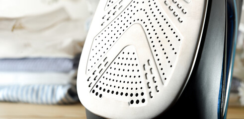 Detail of metal sole and stack of folded shirts