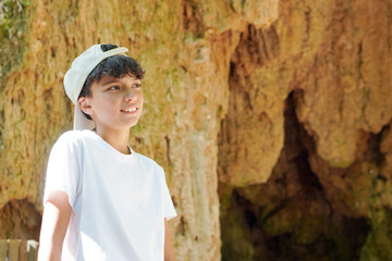 travel and vacation. teenage boy visiting a cave during vacation.