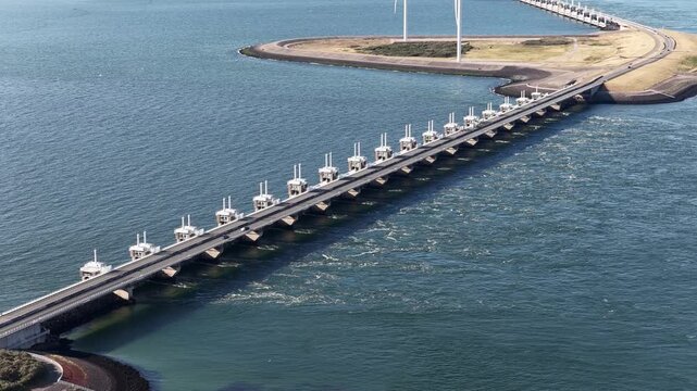 The Oosterscheldekering is a flood barrier in the Netherlands. Part of the Delta Works . road link between Schouwen-Duiveland and Noord-Beveland, part of the N57 highway. Zeeland.