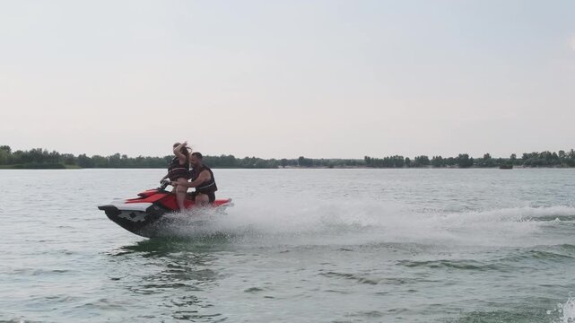 Happy couple riding a jet ski. Concept joy, freedom, and shared adventure.