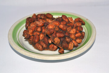 Sweet Delight: Close-up of appetizing peanut brittle candies on a plate.