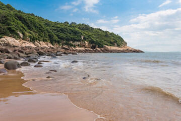Island Shoreline With Gentle Waves And Open Blue Sky Vista