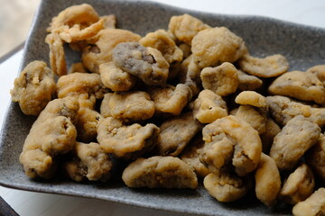 Crispy fried straw mushrooms on a gray plate. Mushrooms are a great substitute for meat.