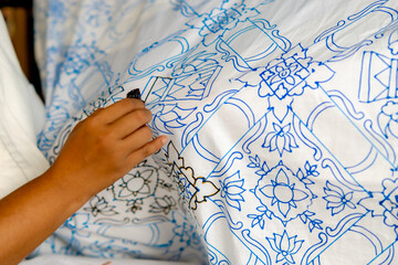 The process of making batik cloth. Batik is a type of cloth whose motifs are drawn manually.