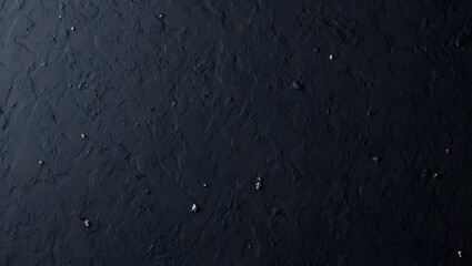 Fototapeta premium Dark Textured Background: Moody Black Surface with Gold Accents, Overhead Shot