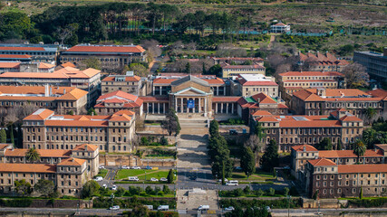 Medium wide aerial view of the University of Cape Town's main campus, with the Sarah Baartman Hall...