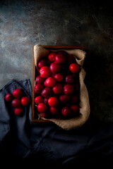 Delicious and Juicy Red Plums.

Vibrant red plums, ripe and ready to eat, arranged in a wooden...