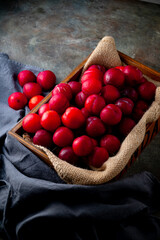 Delicious and Juicy Red Plums.

Vibrant red plums, ripe and ready to eat, arranged in a wooden...