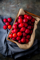 Delicious and Juicy Red Plums.

Vibrant red plums, ripe and ready to eat, arranged in a wooden...
