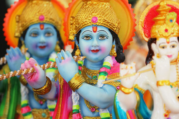Colorful Krishna flute statues, Hindu god figurines, Indian spirituality and religious decor, traditional art