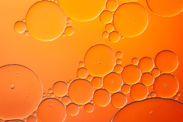 Oil bubbles. Oil bubbles on water in orange tones close-up. Abstract texture