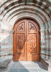 Ancient wooden entrance door at the Chapel of Sacra di San Michele, or or St. Michael Abbey, province of Turin, Piedmont, Italy