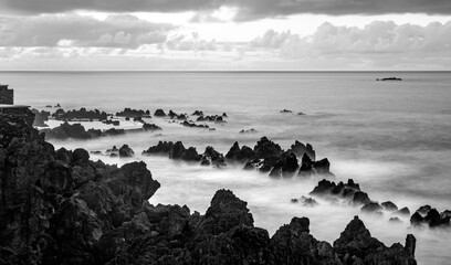 Porto Moniz on the north coast of Madeira island Portugal with a popular natural complex of lava pools perfect for bathing. Dusk sunset seascape panorama with black volcanic rocks, longtime exposure. © ON-Photography