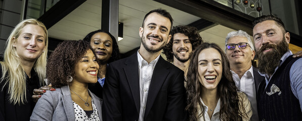 Diverse business team posing together in a corporate office with smiles and positive energy. Group of multiracial colleagues representing workplace unity and inclusion. Real people genuine teamwork.