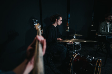 A group of talented musicians practicing a song, featuring drums, bass guitar, and piano. Captured...