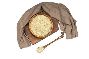 Top view closeup of freshly harvested white sesame in wooden bowl isolated on white background with...