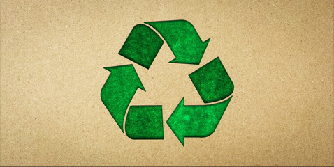 Green recycling symbol on brown paper. Concepts of reducing waste and reusing, symbolism of environmentally friendly products, CSR, zero waste.