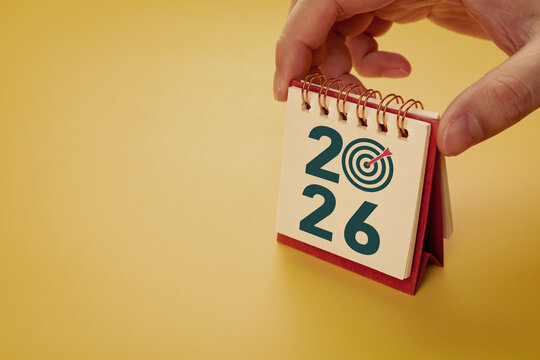 Calendar page of 2026 with target symbol, on yellow background. Concepts of planning for success, setting goals, planning strategies, and taking action steps.