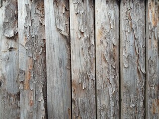 the back wall of a wooden house that has been exposed to the sun for a long time