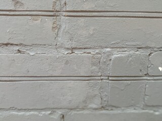 the brick wall of the basement is painted gray