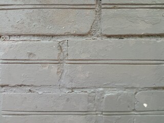 the brick wall of the basement is painted gray
