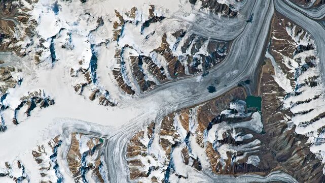 Aerial shot of glaciers covered with snow in mountainous area. Camera is moving backward and right. Animation based on image by NASA