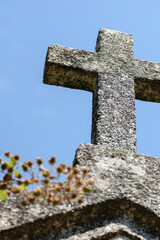 Granite cross on a sunny day with clear blue sky background.