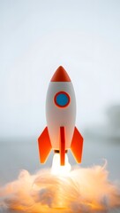 Stock image of toy rocket launch with smoke for startup business and innovation ideas