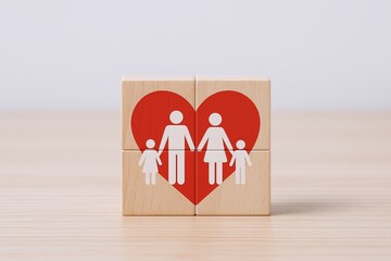 Four wooden blocks with stylized man and woman icons forming a heart shape on a light surface.