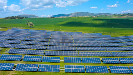 Rows of solar panels on a green meadow in Greece.