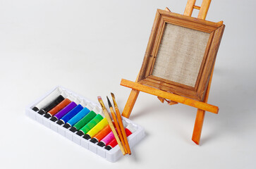 Canvas on a stretcher, art paints and brushes.