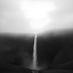 monochrome landscape presents a dramatic waterfall cascading down a solitary, dark mountain