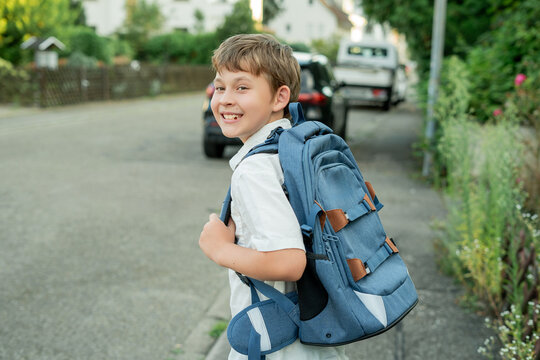 Portrait of a schoolboy with a backpack on the street. Back to school. Studying.
