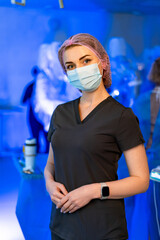Clinical healthcare professional. A healthcare worker dressed in scrubs stands confidently, wearing...
