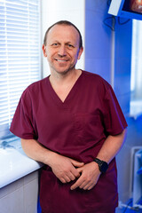 Doctor smiles in clinic setting. A healthcare professional stands confidently in a modern clinic,...