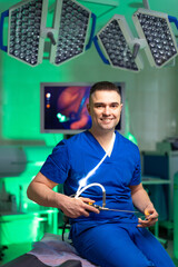 Doctor smiling in modern surgical room. A doctor in blue scrubs sits confidently in a high-tech...
