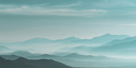 Soft light hanging over distant mountain range with clouds
